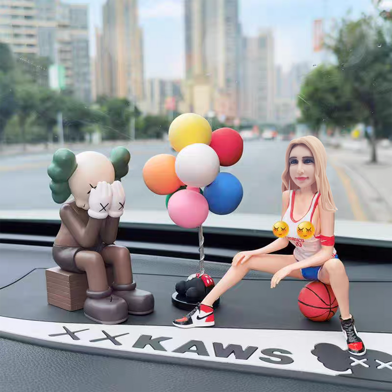 Car-mounted custom bobblehead doll of woman sitting on basketball